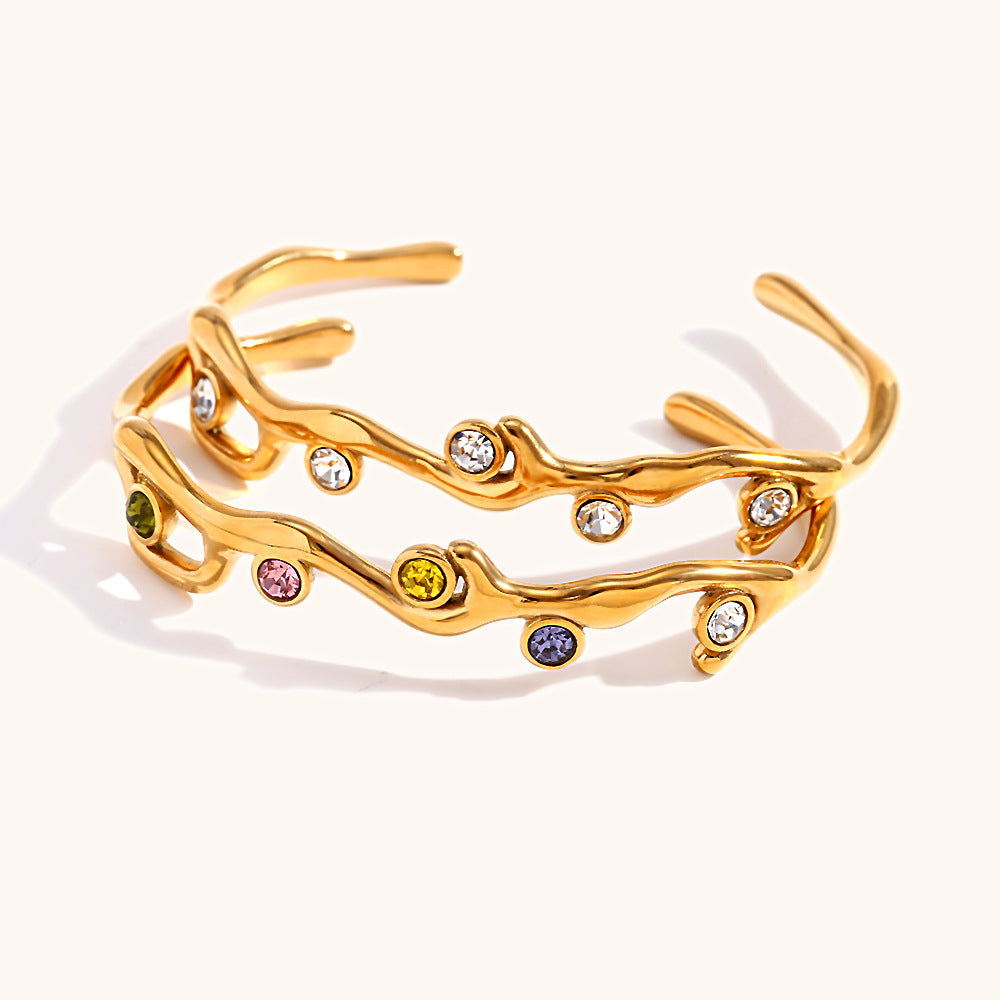 Colored diamond bracelet with stainless steel branches plated with 18K gold.