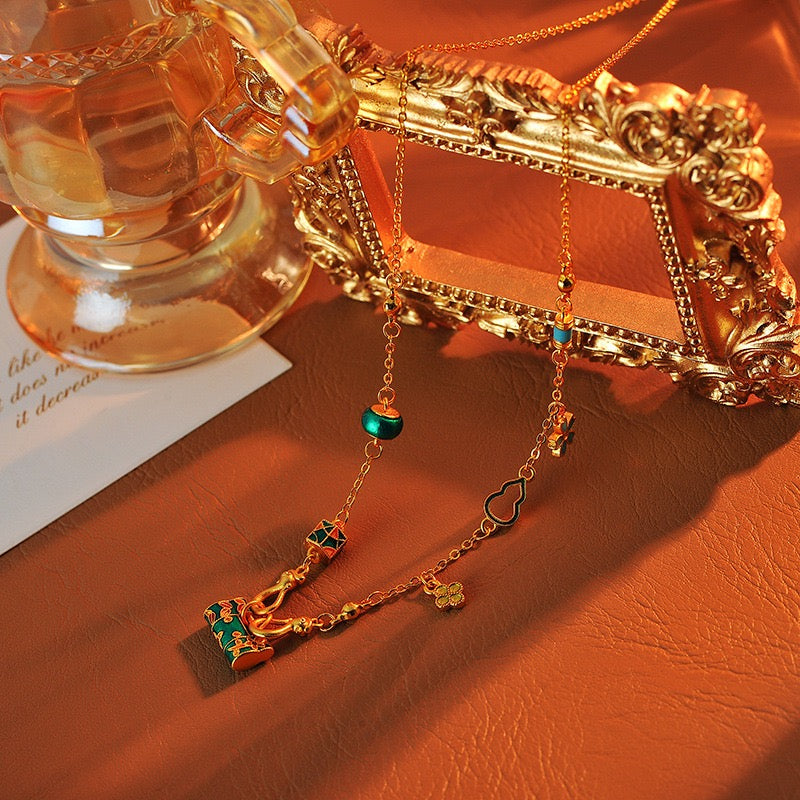 ゴールドバーニングブルーエナメルロックバッグネックレス