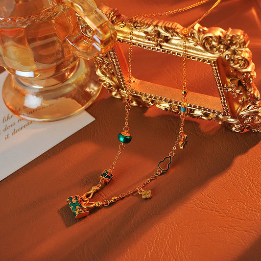 ゴールドバーニングブルーエナメルロックバッグネックレス